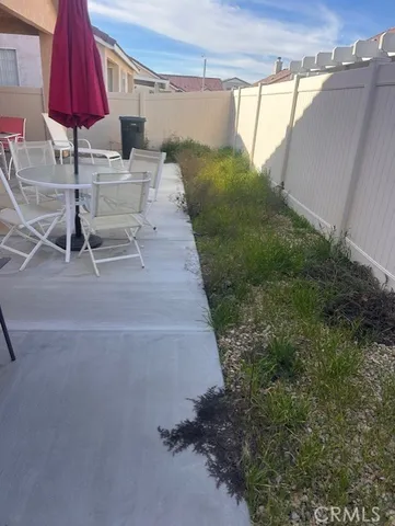 a view of a backyard with furniture and a small cabin