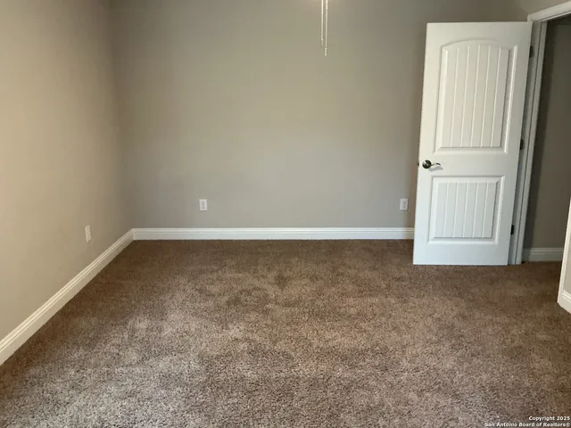 a kitchen with granite countertop wooden cabinets and stainless steel appliances