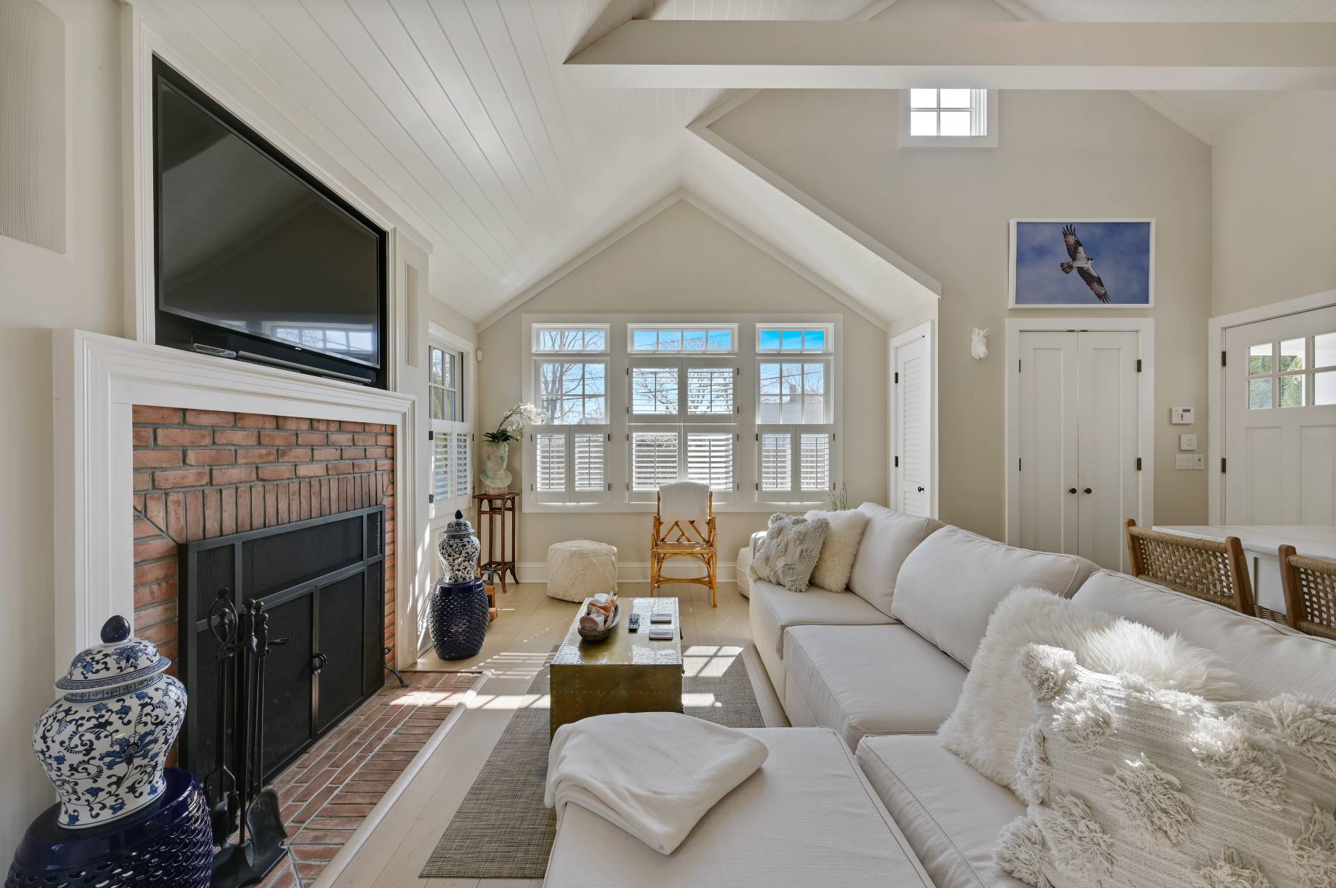 5 Ridge Drive Sag Harbor, NY 11963 - Photo 2 of 27 a living room with furniture a flat screen tv and a fireplace