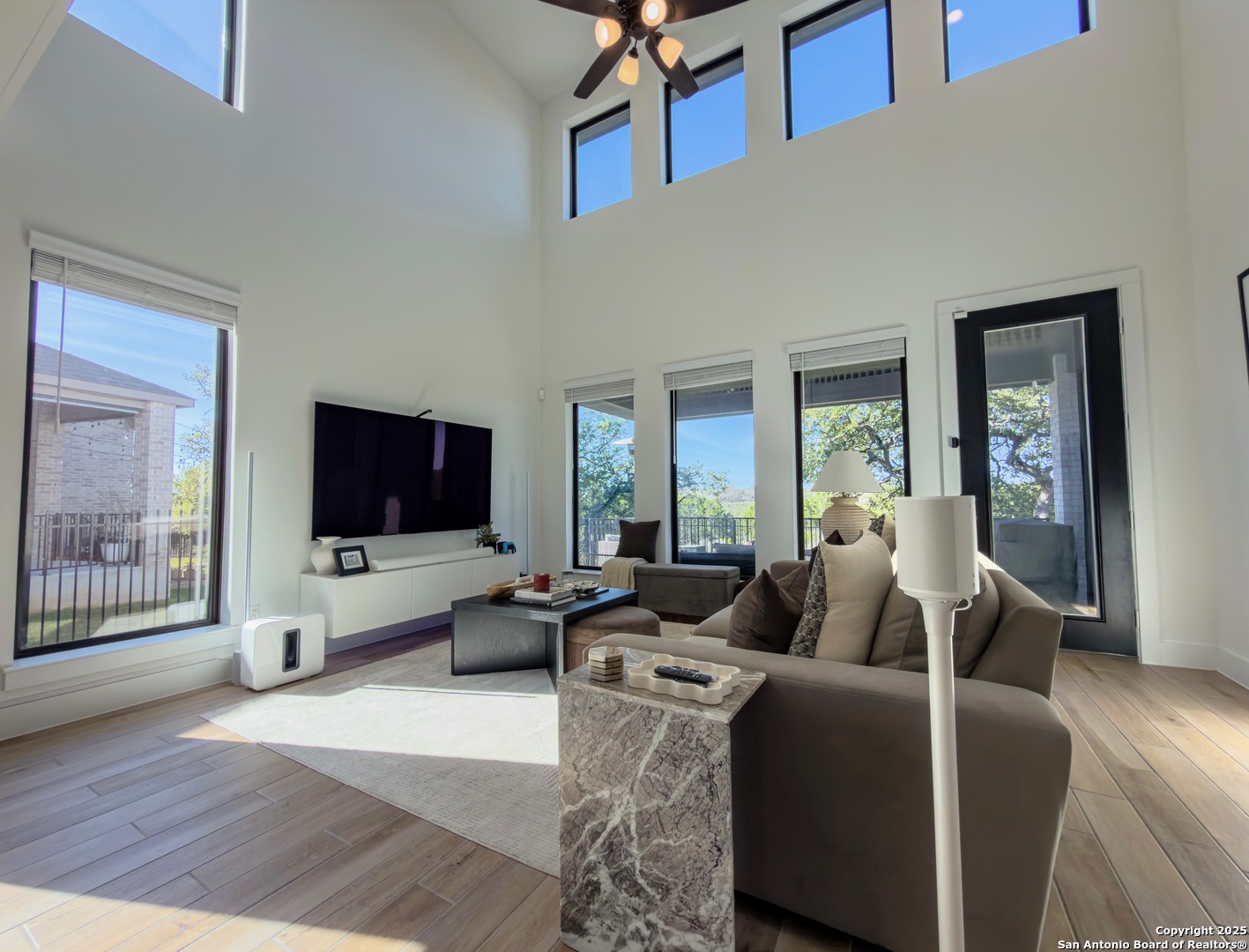 416 Kimble Creek Loop Kyle, TX 78640 - Photo 13 of 29 a living room with furniture wooden floor and a flat screen tv