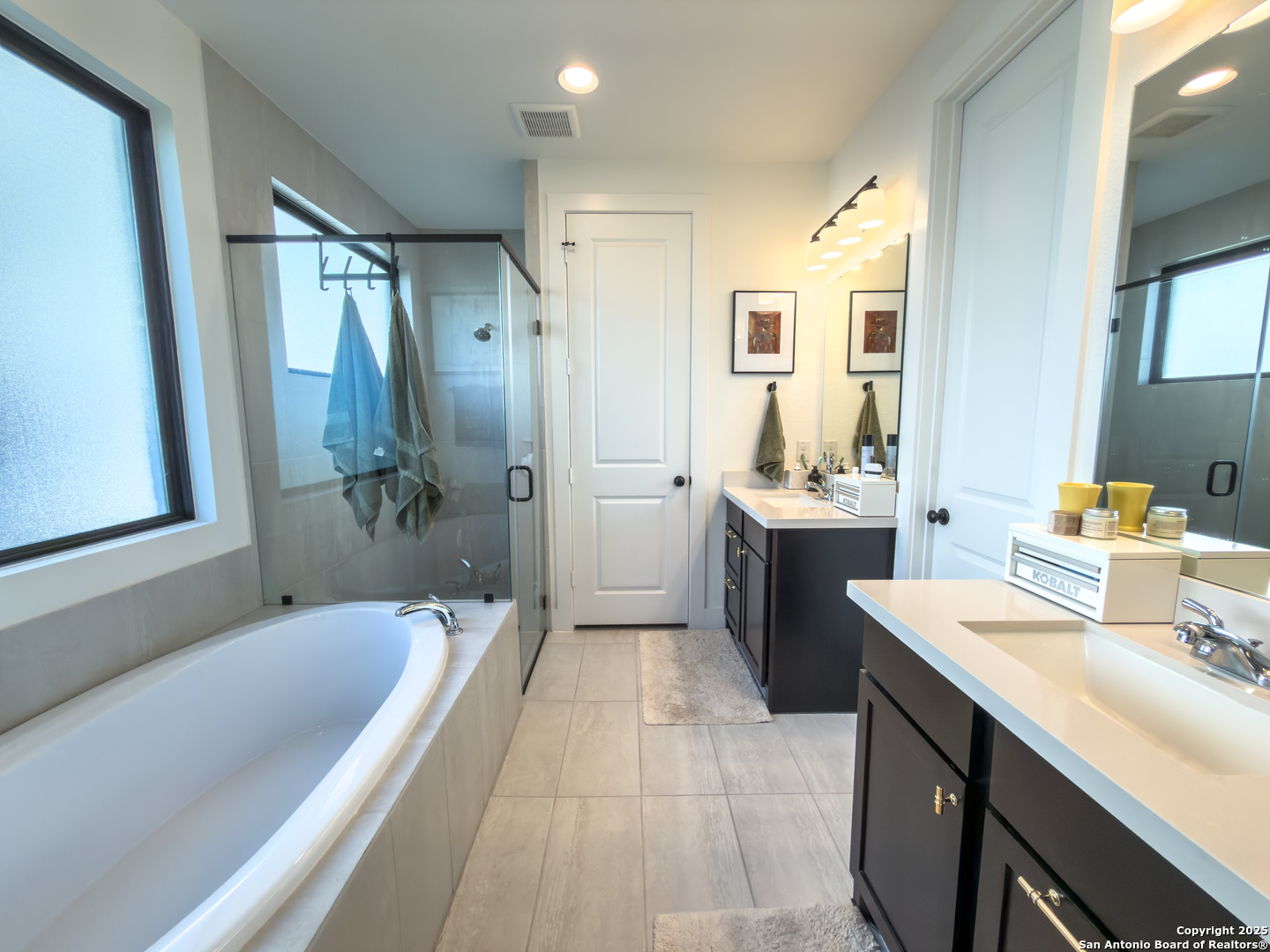 416 Kimble Creek Loop Kyle, TX 78640 - Photo 17 of 29 a bathroom with a tub sink shower and mirror
