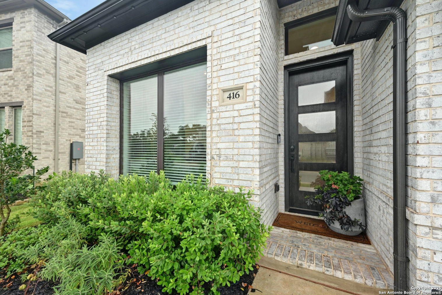 416 Kimble Creek Loop Kyle, TX 78640 - Photo 2 of 29 a potted plant in front of a house