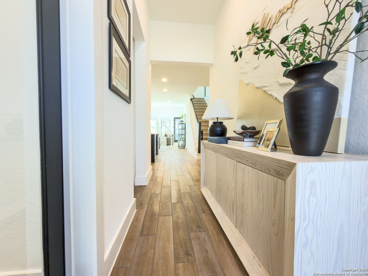 416 Kimble Creek Loop Kyle, TX 78640 - Photo 4 of 29 a view of a hallway with wooden floor and staircase