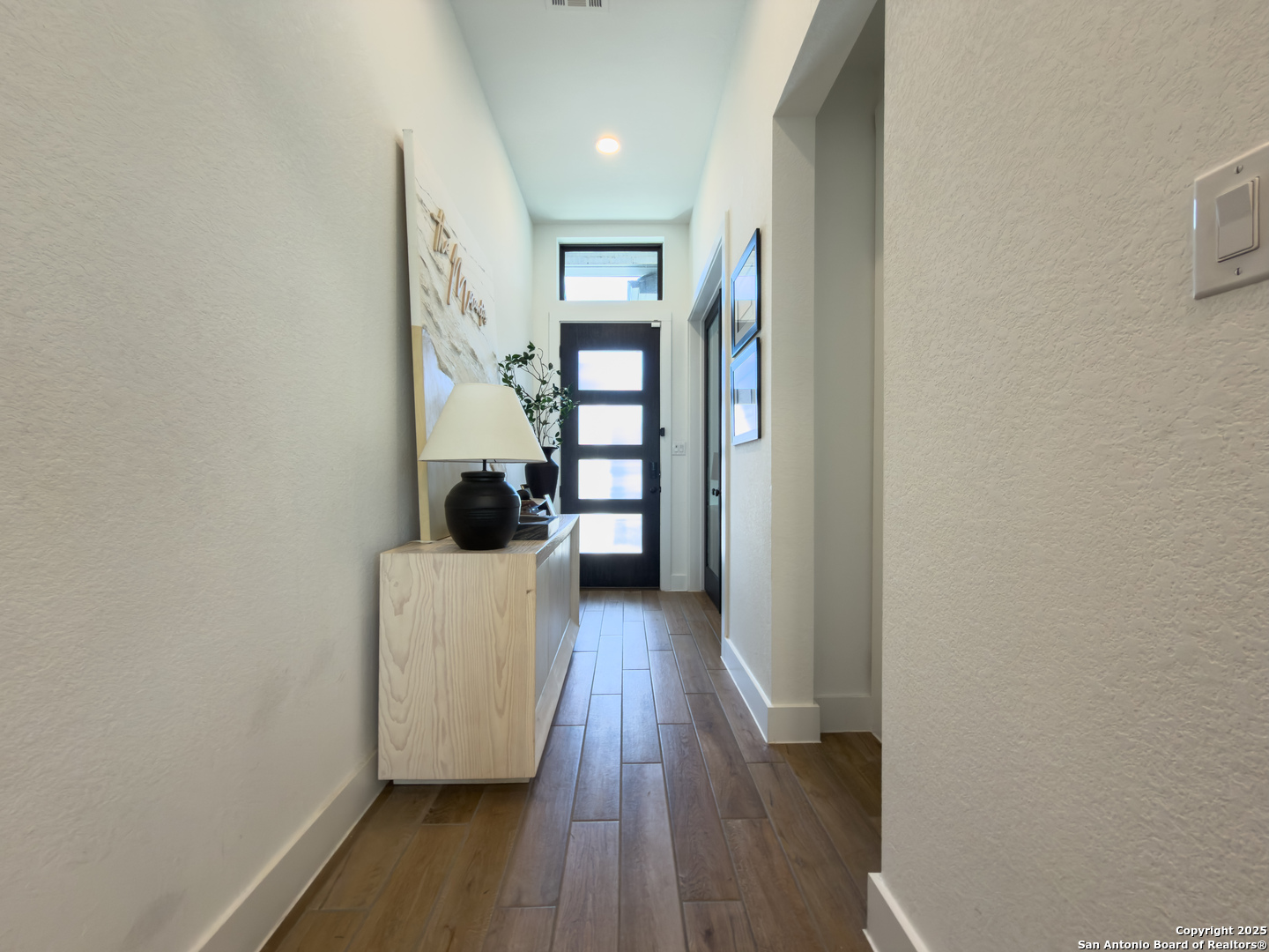 416 Kimble Creek Loop Kyle, TX 78640 - Photo 5 of 29 a hallway with wooden floor furniture and entryway