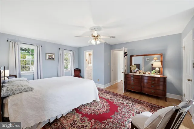a front view of a house with garden and trees