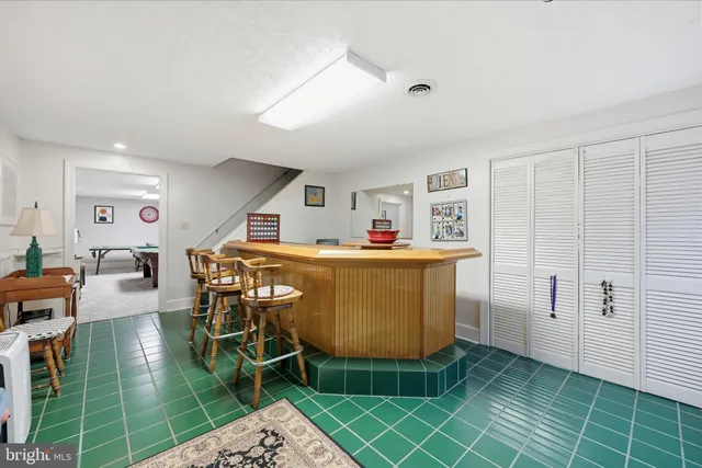 a view of a house with a yard and hanging chair