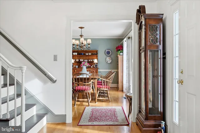 a dining room with furniture a rug and a chandelier