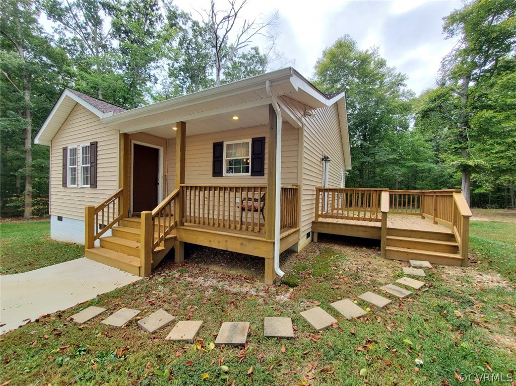 10140 Reed Rock Road Amelia Court House, VA 23002 - Photo 7 of 27 a view of a house with a wooden deck and a yard