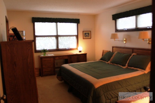 372 Heritage Ridge Road Boone, NC 28607 - Photo 14 of 34 a bedroom with a bed and a window