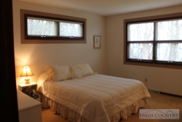 372 Heritage Ridge Road Boone, NC 28607 - Photo 15 of 34 a bedroom with a bed and a window