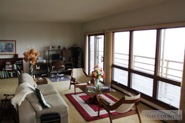 372 Heritage Ridge Road Boone, NC 28607 - Photo 18 of 34 a living room with furniture and floor to ceiling windows