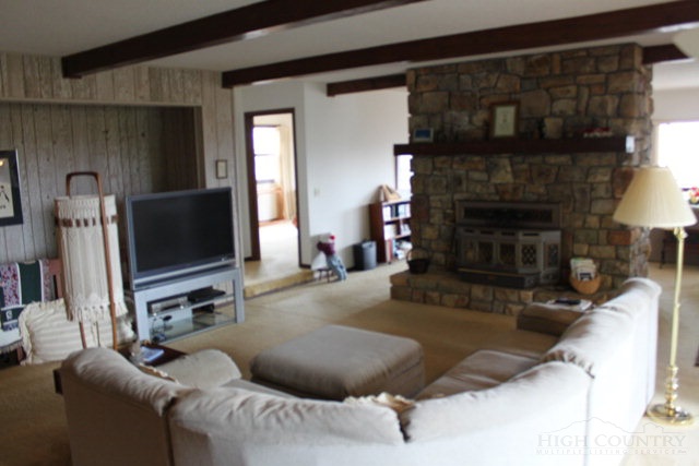 372 Heritage Ridge Road Boone, NC 28607 - Photo 5 of 34 a living room with furniture and a fireplace