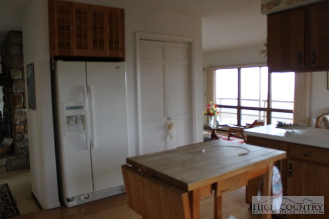 372 Heritage Ridge Road Boone, NC 28607 - Photo 6 of 34 a kitchen with a table a refrigerator and window