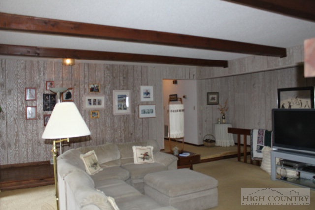 372 Heritage Ridge Road Boone, NC 28607 - Photo 8 of 34 a living room with furniture and a flat screen tv