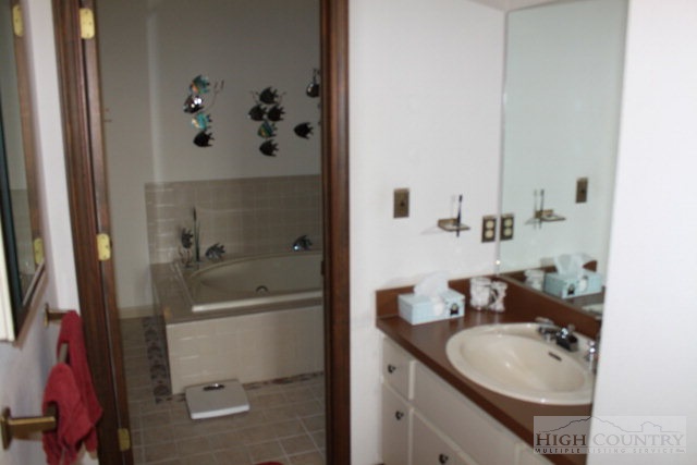 372 Heritage Ridge Road Boone, NC 28607 - Photo 10 of 34 a bathroom with a granite countertop sink toilet and shower