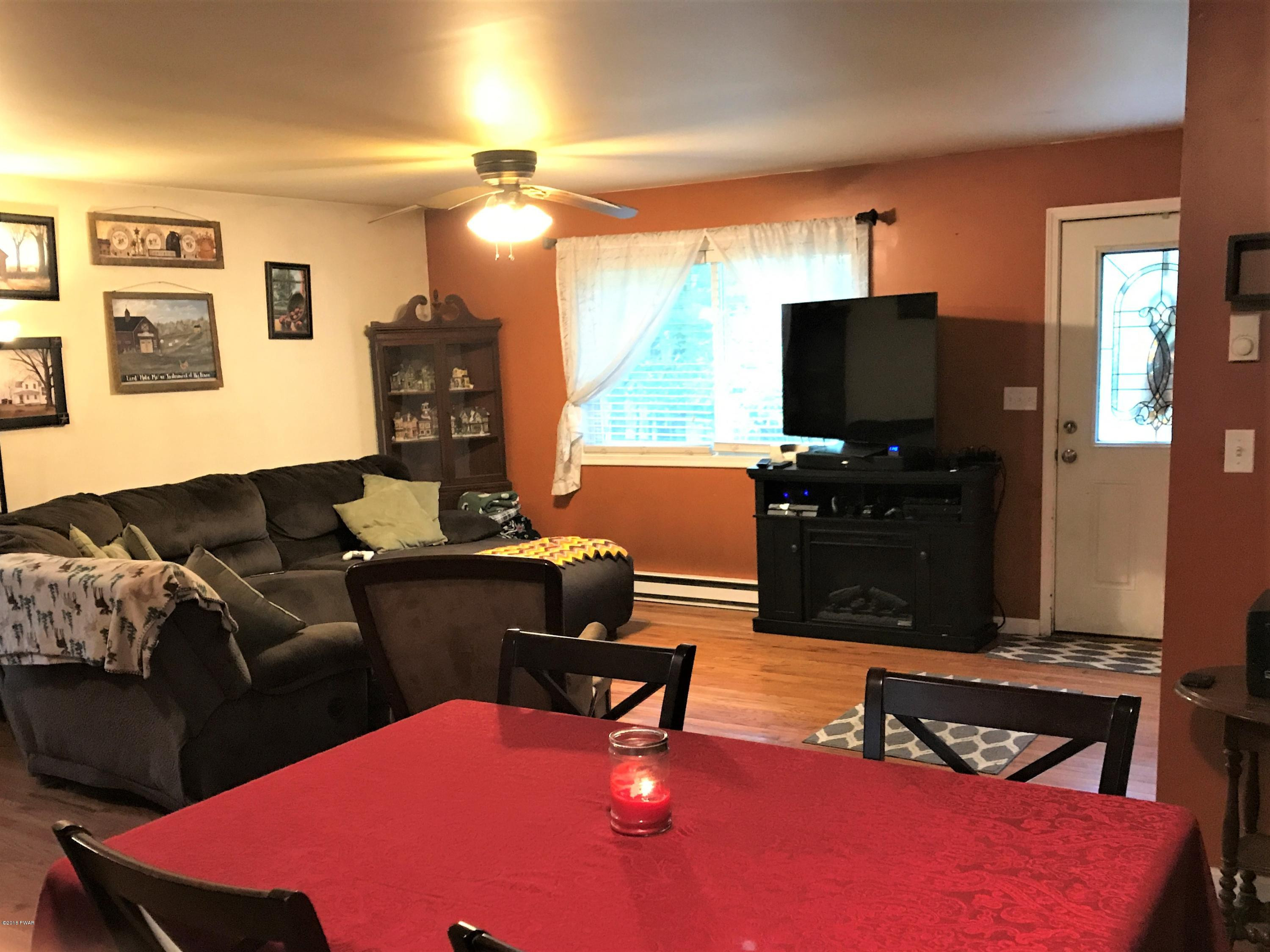 151 Raccoon Road Dingmans Ferry, PA 18328 - Photo 13 of 29 a living room with furniture and a flat screen tv