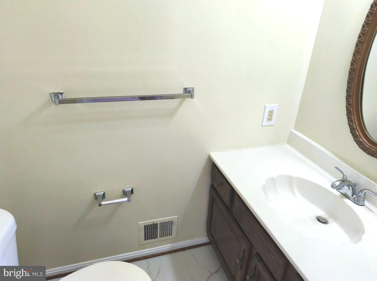 12452 Sweet Leaf Terrace Fairfax, VA 22033 - Photo 15 of 38 a bathroom with a sink and a mirror