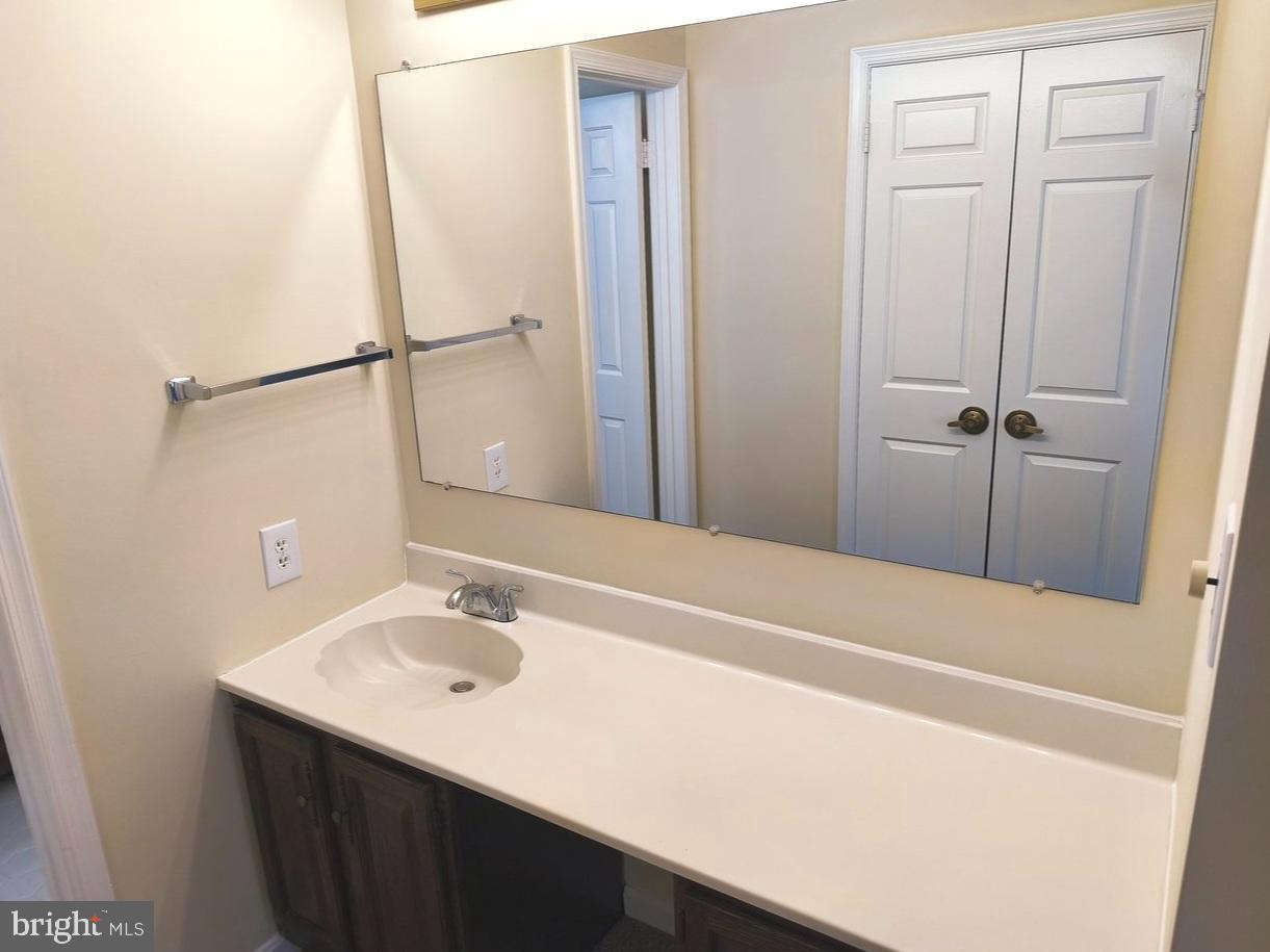 12452 Sweet Leaf Terrace Fairfax, VA 22033 - Photo 21 of 38 a bathroom with a sink and a mirror