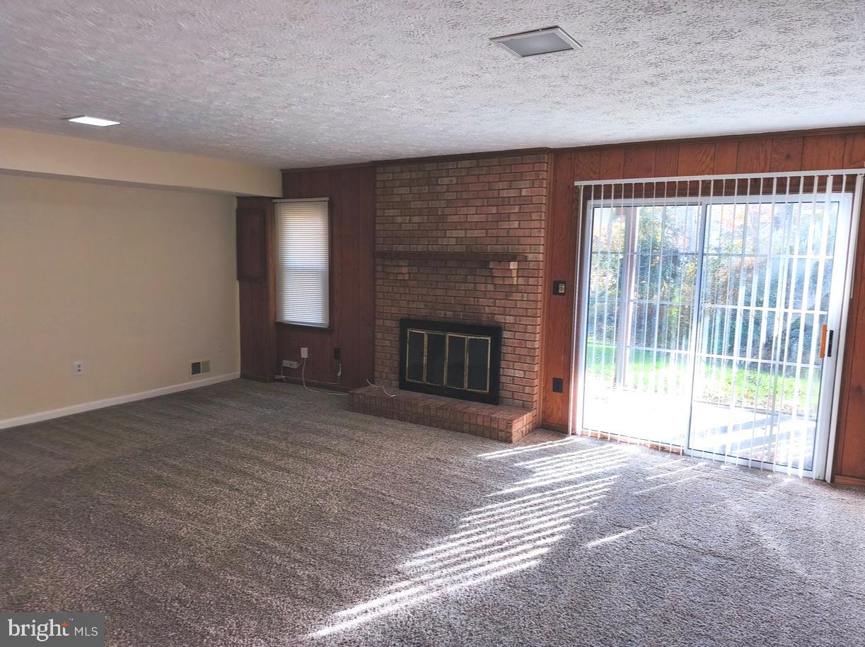 12452 Sweet Leaf Terrace Fairfax, VA 22033 - Photo 30 of 38 a view of an empty room with a fireplace and a window