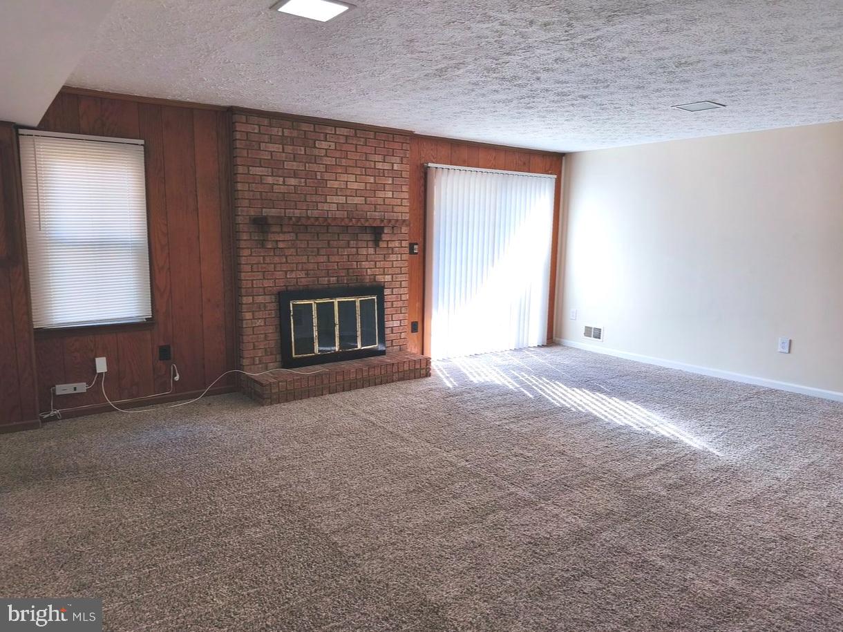 12452 Sweet Leaf Terrace Fairfax, VA 22033 - Photo 32 of 38 a view of an empty room with a fireplace and a window