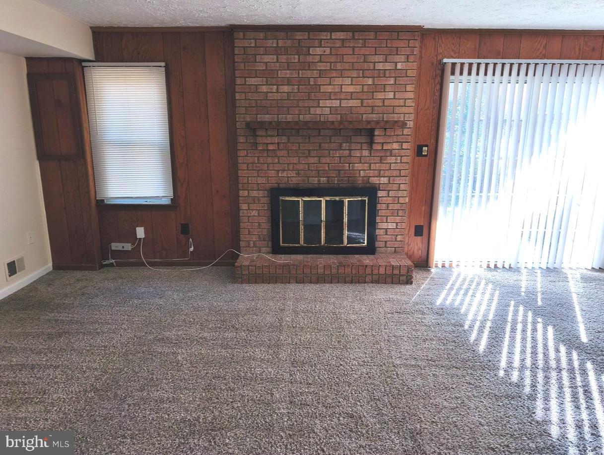 12452 Sweet Leaf Terrace Fairfax, VA 22033 - Photo 35 of 38 a view of empty room with wooden floor and fireplace