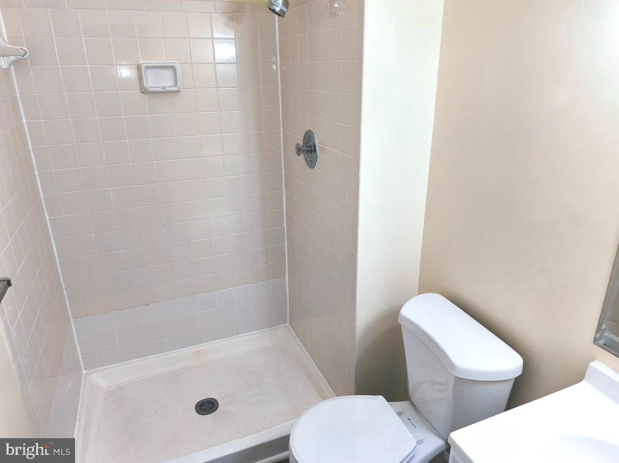 12452 Sweet Leaf Terrace Fairfax, VA 22033 - Photo 36 of 38 a white toilet sitting next to a bath tub