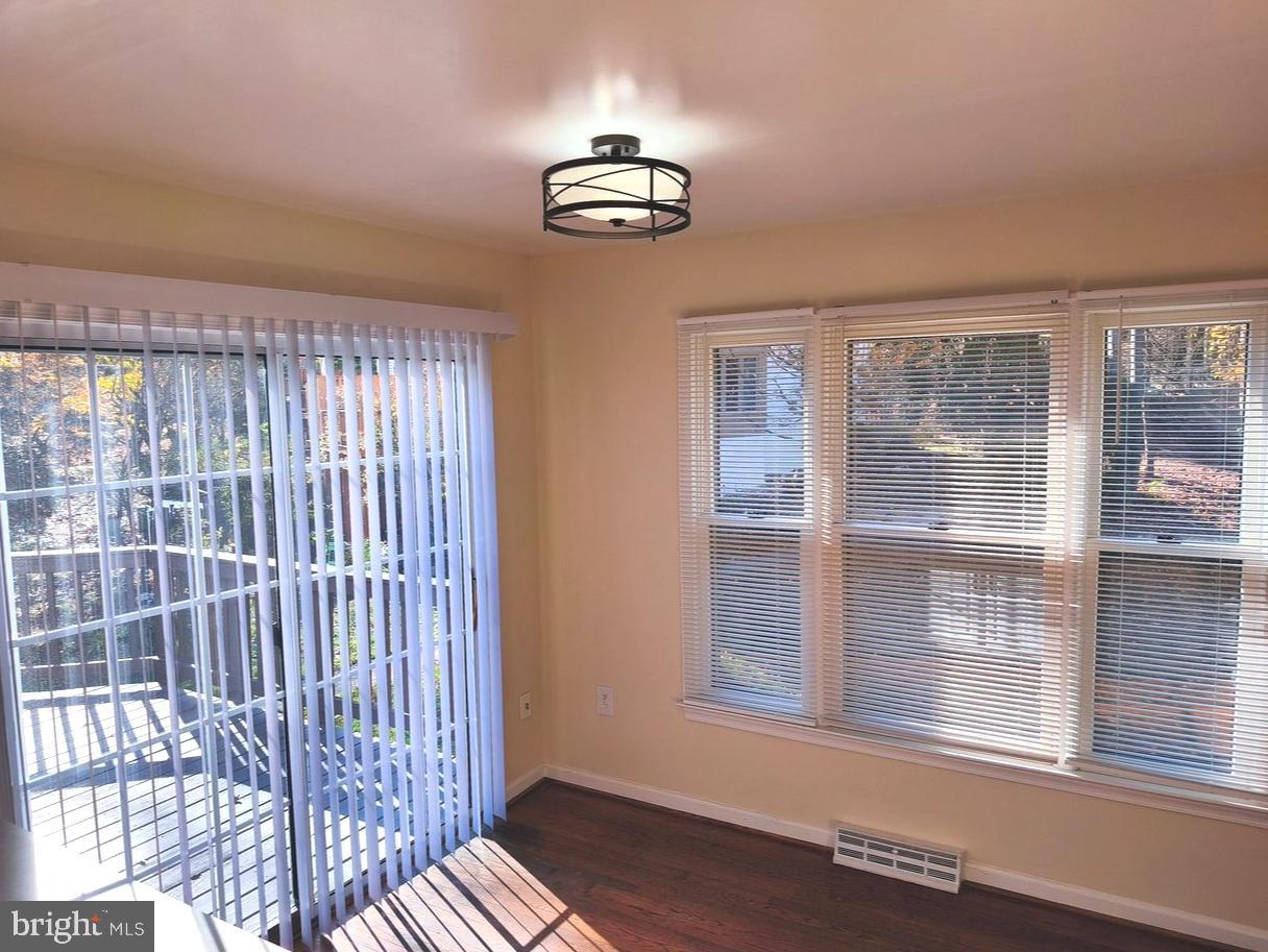 12452 Sweet Leaf Terrace Fairfax, VA 22033 - Photo 7 of 38 a view of wooden floor and windows in an empty room