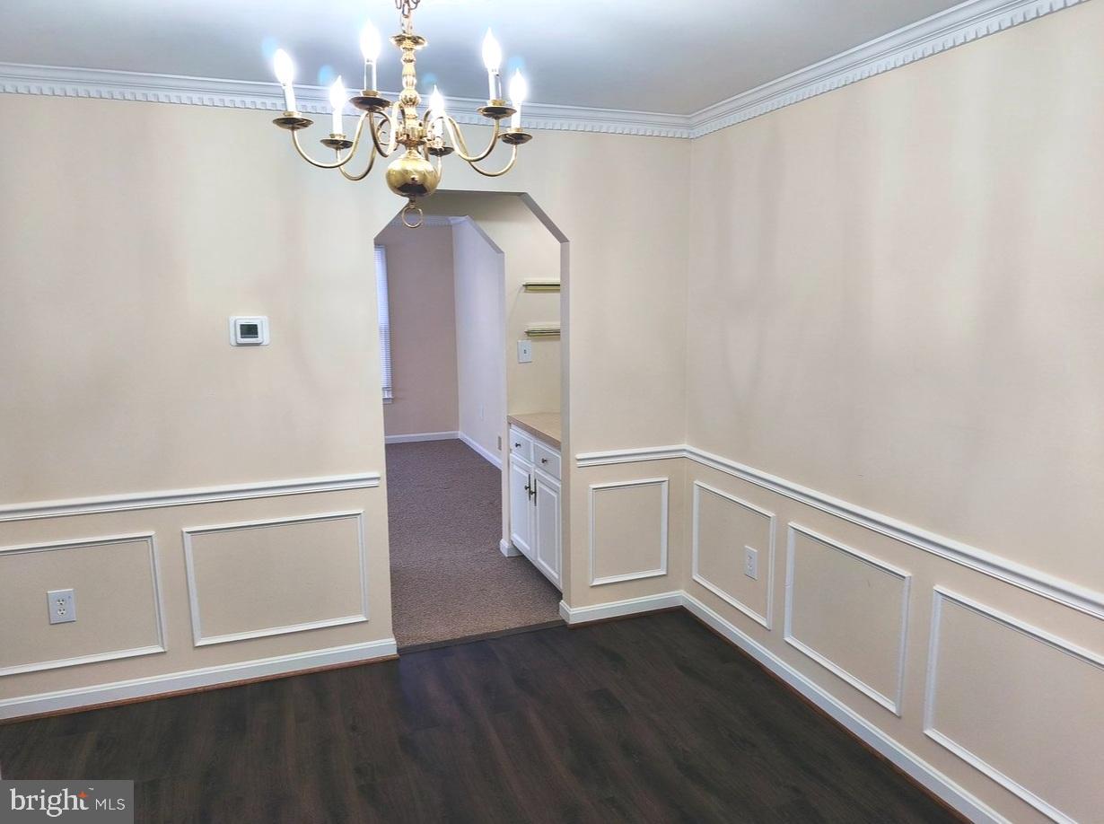 12452 Sweet Leaf Terrace Fairfax, VA 22033 - Photo 10 of 38 a view of an empty room with wooden floor and a window