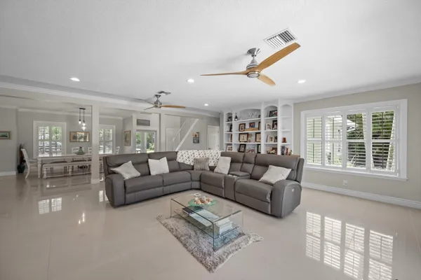 a kitchen with stainless steel appliances granite countertop a refrigerator and a stove top oven with wooden floor