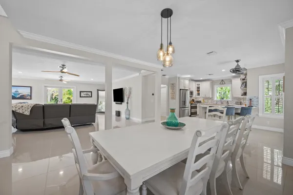 a kitchen with granite countertop a refrigerator stove and sink