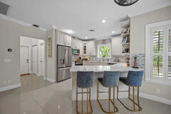 a kitchen with stainless steel appliances granite countertop a sink and cabinets