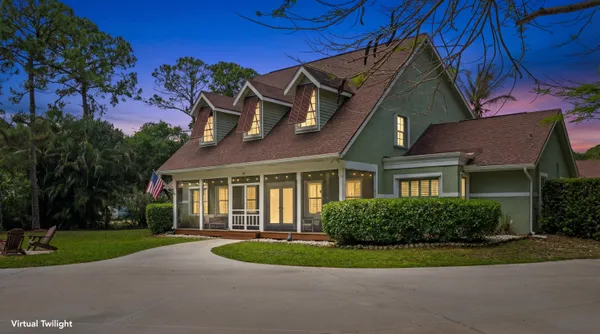a view of a big house with a big yard and potted plants
