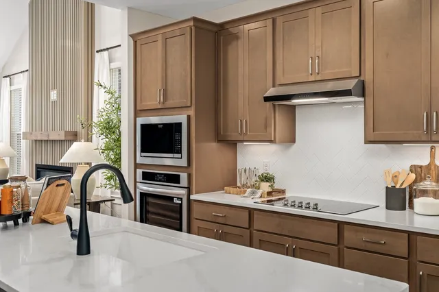 a kitchen with stainless steel appliances granite countertop a stove and a refrigerator