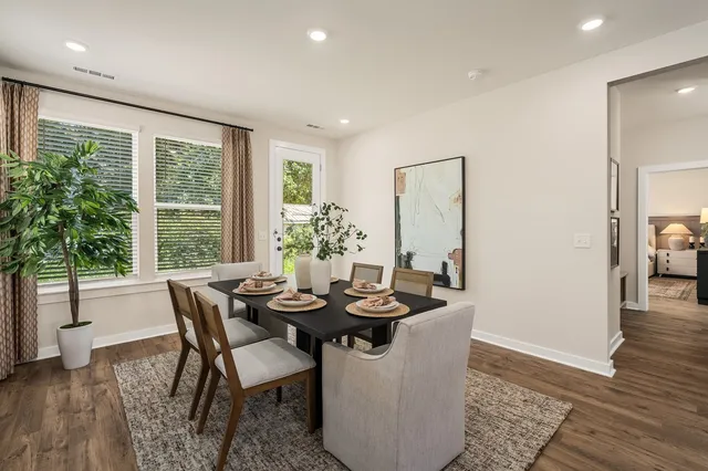 a dining room with furniture and wooden floor