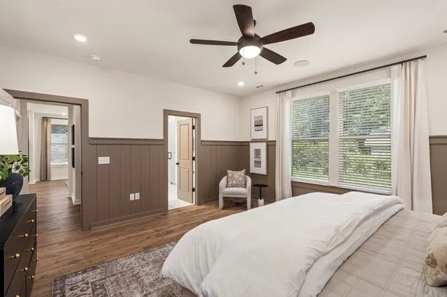 a bedroom with a large bed and a large window