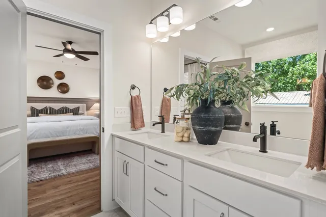 a bathroom with a double vanity sink a mirror and shower