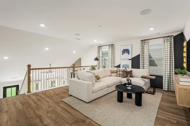 a living room with furniture windows and a flat screen tv