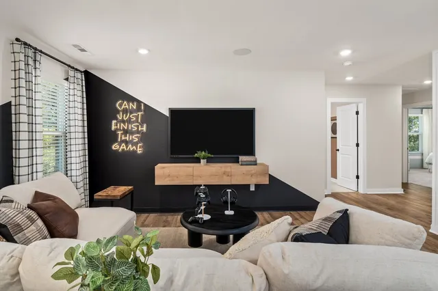 a living room with furniture and a flat screen tv