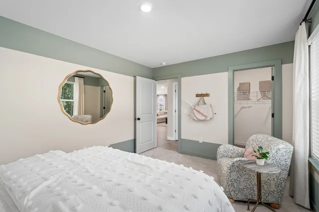 a bedroom with a bed and chair