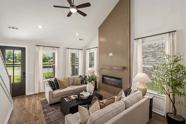 a living room with furniture and a potted plant