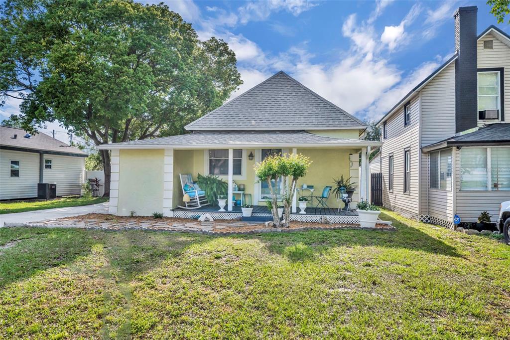 a house view with swimming pool and porch