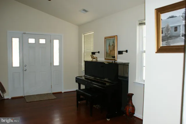 a room with wooden floor and furniture