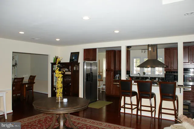 a kitchen with stainless steel appliances a dining table and chairs