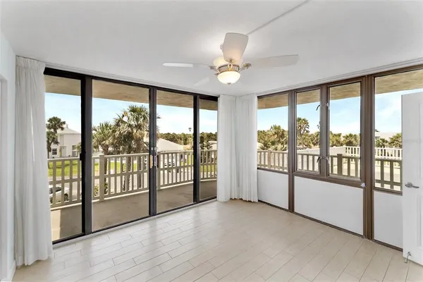 a room with gym equipment and wooden floor