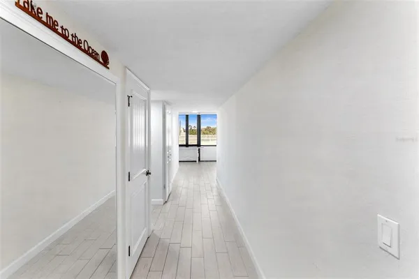 a big room with wooden floor and windows