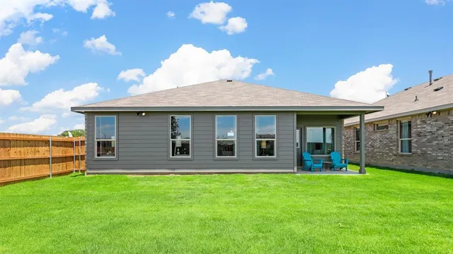 a view of a house with a yard and sitting area