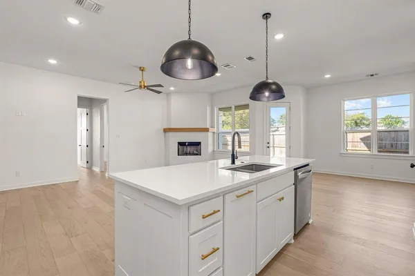 a kitchen with a counter space a sink and a window
