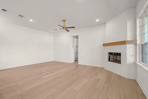 a view of empty room with a fireplace