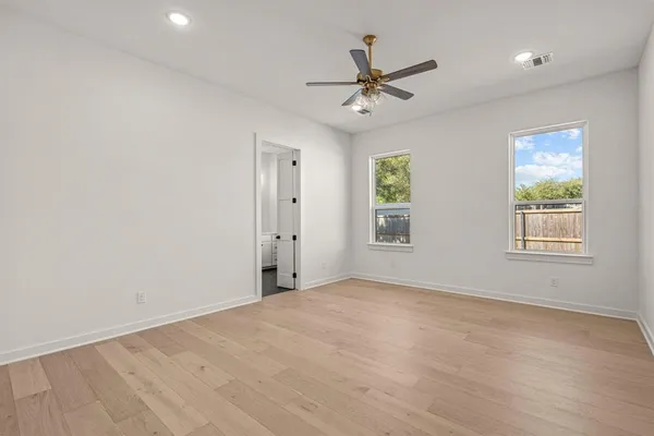 a view of a room with a window and a ceiling fan