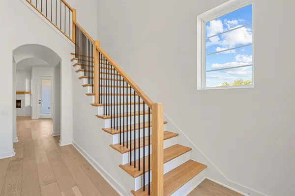a view of entryway and hall with wooden floor